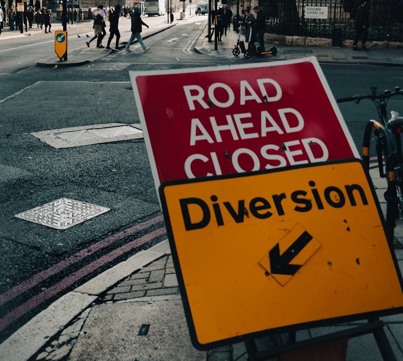 a road ahead closed sign on the side of the road